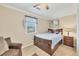 Cozy bedroom with wood-look flooring, a double bed, and a ceiling fan at 690 Percheron, Nokomis, FL 34275