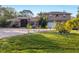 Two-story house with a large driveway and landscaped yard at 690 Percheron, Nokomis, FL 34275
