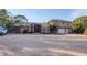 Two-story house with a paver driveway and tropical landscaping at 690 Percheron, Nokomis, FL 34275