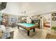 Game room boasts a pool table, fireplace, and views to another room at 690 Percheron, Nokomis, FL 34275