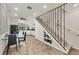 Kitchen and dining area with glass table and staircase with wrought iron railing at 690 Percheron, Nokomis, FL 34275