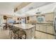 Kitchen with granite island, white cabinets and stainless steel appliances at 690 Percheron, Nokomis, FL 34275