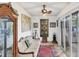 Bright sunroom features a comfortable sofa, stained glass window, and access to backyard at 690 Percheron, Nokomis, FL 34275