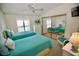 Guest bedroom with twin beds, mirrored closet, and white wicker chair at 701 S Green Cir, Venice, FL 34285