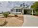 Single-wide home with carport and landscaped yard at 701 S Green Cir, Venice, FL 34285