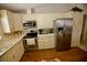 Kitchen with stainless steel appliances and light-colored cabinets at 701 S Green Cir, Venice, FL 34285