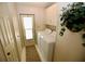 Bright laundry room, featuring washer, dryer, and ample storage at 701 S Green Cir, Venice, FL 34285