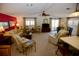 Spacious living room with comfy furniture, a large TV, and a ceiling fan at 701 S Green Cir, Venice, FL 34285
