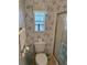 Simple bathroom with toilet, shower, and floral wallpaper at 723 Locarno Dr, Venice, FL 34285