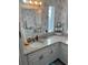 Charming bathroom with granite countertop, updated vanity, and floral wallpaper at 723 Locarno Dr, Venice, FL 34285