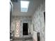 Bathroom with skylight, vanity, and floral wallpaper at 723 Locarno Dr, Venice, FL 34285