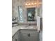 Bright bathroom featuring a vanity with granite countertop and floral wallpaper at 723 Locarno Dr, Venice, FL 34285