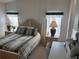 Bedroom with wood furniture, bedding, and two windows at 723 Locarno Dr, Venice, FL 34285