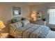 Main bedroom with a queen-size bed and wicker furniture at 723 Locarno Dr, Venice, FL 34285