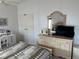 Bedroom with dresser, TV, and ceiling fan at 723 Locarno Dr, Venice, FL 34285
