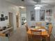 Dining area with wood table and chairs, view into living room and bedroom at 723 Locarno Dr, Venice, FL 34285