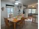 Bright dining area with wood table and chairs, view into kitchen at 723 Locarno Dr, Venice, FL 34285