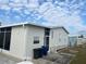 Side view of a mobile home, showing additional exterior features at 723 Locarno Dr, Venice, FL 34285