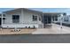 Mobile home exterior with covered porch and landscaped yard at 723 Locarno Dr, Venice, FL 34285