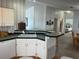 Kitchen with double sink, dishwasher, and view of dining area at 723 Locarno Dr, Venice, FL 34285