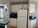 White kitchen with appliances and view of dining area at 723 Locarno Dr, Venice, FL 34285