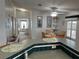 Open kitchen and dining area with breakfast bar and view of living room at 723 Locarno Dr, Venice, FL 34285