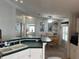 Open kitchen and dining area with breakfast bar and view of bedroom at 723 Locarno Dr, Venice, FL 34285