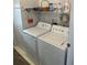 Laundry room with washer, dryer, and shelving at 723 Locarno Dr, Venice, FL 34285