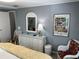 Bedroom with dresser, chair, and Sarasota artwork at 788 Cervina Dr, Venice, FL 34285