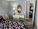 Bedroom with a dresser, bed, and view into another room at 788 Cervina Dr, Venice, FL 34285