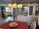Bright dining room with chandelier and view into living area at 788 Cervina Dr, Venice, FL 34285