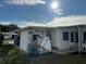 Side view of the manufactured home showing additional landscaping at 788 Cervina Dr, Venice, FL 34285