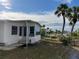 Front view of manufactured home with water view in the background at 788 Cervina Dr, Venice, FL 34285