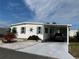 White single-wide manufactured home with carport and landscaped yard at 788 Cervina Dr, Venice, FL 34285