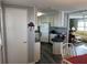 Kitchen features white cabinets and a curved granite countertop at 788 Cervina Dr, Venice, FL 34285