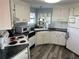 Efficient kitchen featuring white cabinets and dark countertops at 788 Cervina Dr, Venice, FL 34285