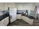 White kitchen with granite countertops and ample cabinet space at 788 Cervina Dr, Venice, FL 34285