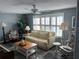 Living room with beige sofa, rocking chair and coffee table at 788 Cervina Dr, Venice, FL 34285