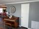 Living room with piano, built-in shelving, and hardwood floors at 788 Cervina Dr, Venice, FL 34285