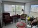 Sunroom features a view, wicker furniture, and tiled floors at 788 Cervina Dr, Venice, FL 34285