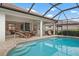 Resort-style pool with screened lanai and plenty of seating at 825 Adonis Pl, Venice, FL 34292