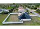 Aerial view of a house with a fenced backyard and solar panels at 8307 Glover Ave, North Port, FL 34291