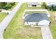 Aerial view of a single-story house with a fenced backyard and solar panels at 8307 Glover Ave, North Port, FL 34291