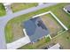An aerial view showcasing a house with solar panels and a large backyard at 8307 Glover Ave, North Port, FL 34291