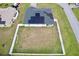 Aerial view of house with solar panels and fenced backyard at 8307 Glover Ave, North Port, FL 34291