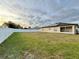 View of the backyard showing a large grassy area and a privacy fence at 8307 Glover Ave, North Port, FL 34291