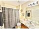 Bathroom with a shower/tub, a toilet, single sink vanity, and decorative hexagon shelves at 8307 Glover Ave, North Port, FL 34291