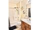 Bathroom featuring a shower/tub combination, single sink vanity, and decorative hexagon shelves at 8307 Glover Ave, North Port, FL 34291