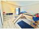 Playful bedroom with a wooden bunk bed with a slide, soft blue carpets, and storage cubes at 8307 Glover Ave, North Port, FL 34291