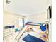 Playful bedroom with a wooden bunk bed with a slide, soft blue carpets, and storage cubes at 8307 Glover Ave, North Port, FL 34291